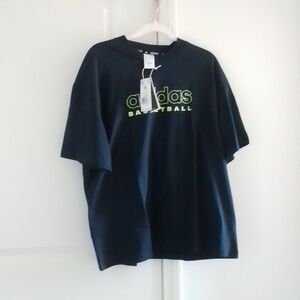 NWT Adidas black shirt with green writing that says basketball